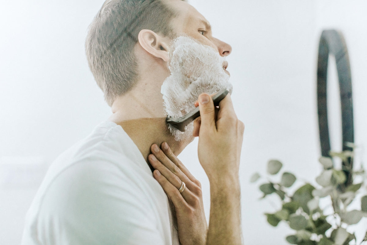 man shaving his beard Image