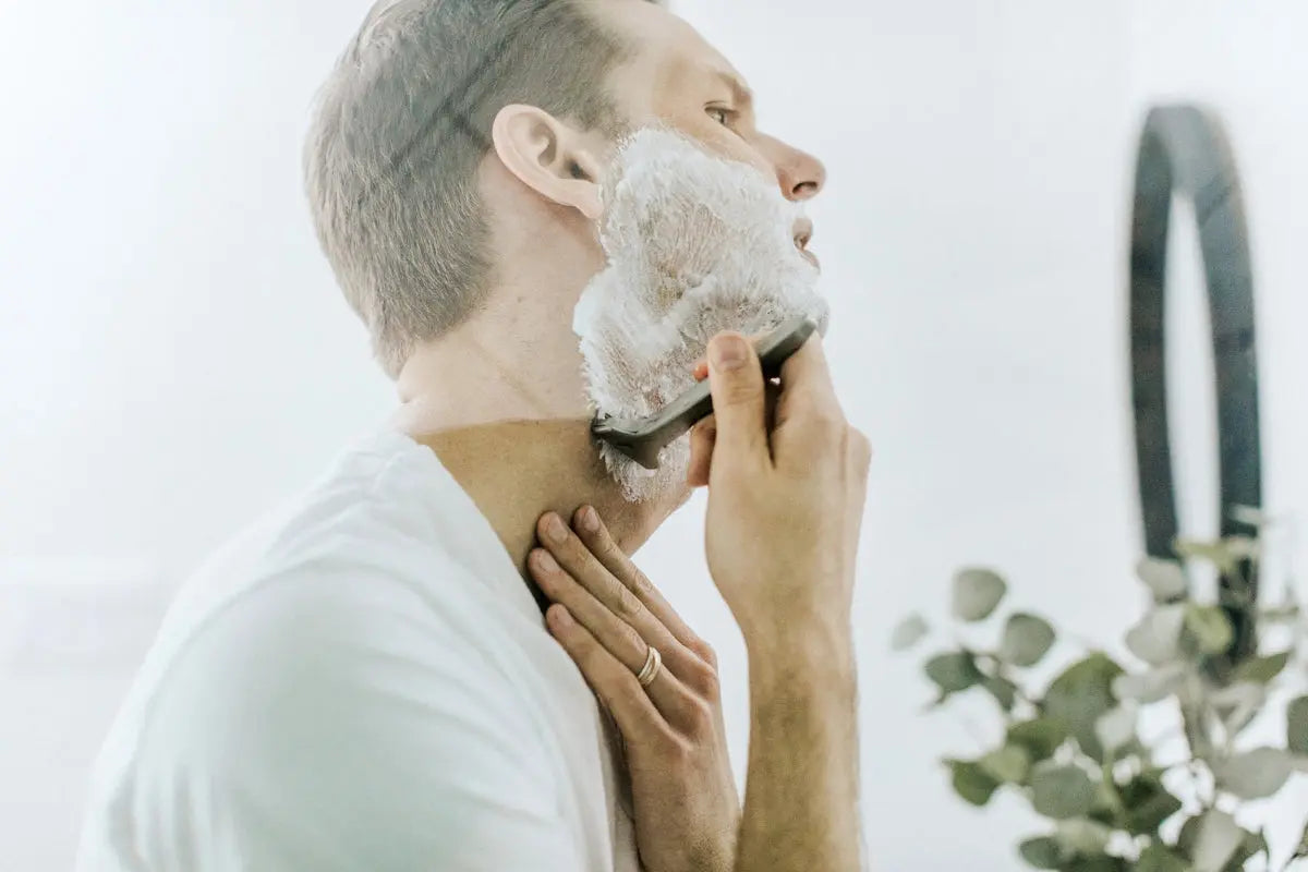 man shaving his beard Image
