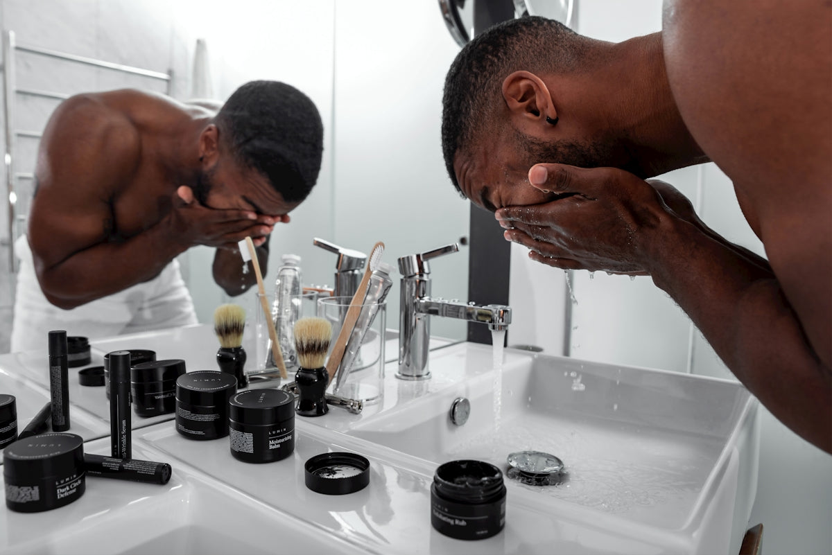 man standing in front of sink Image