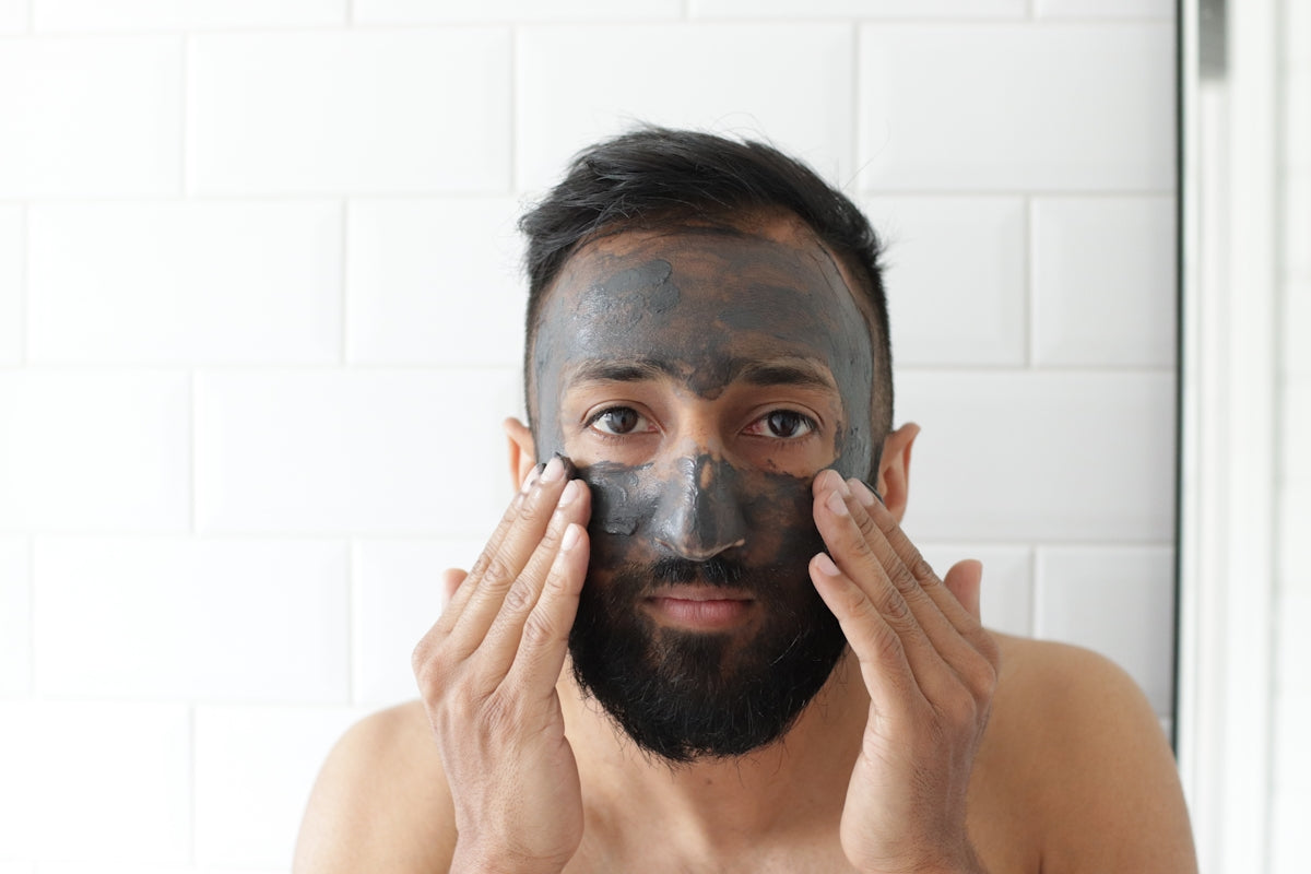 topless man covering face with white powder Image