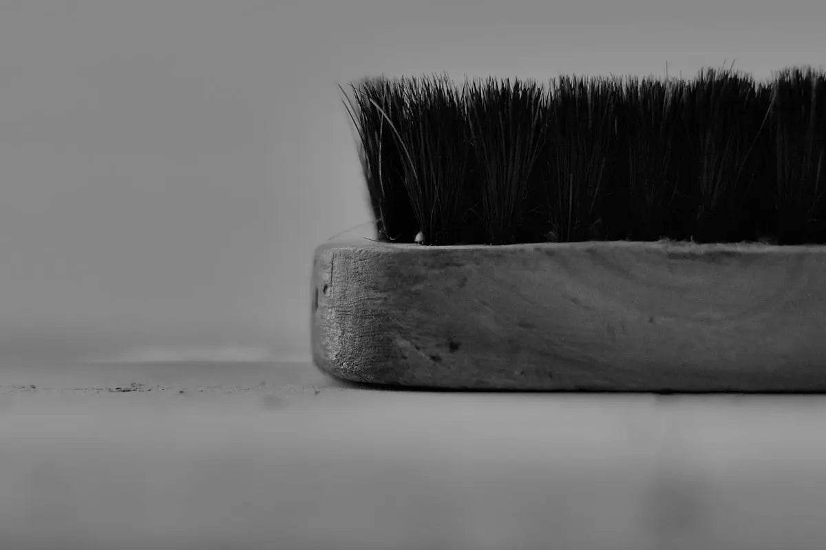 grayscale photo of brush on wooden board Image