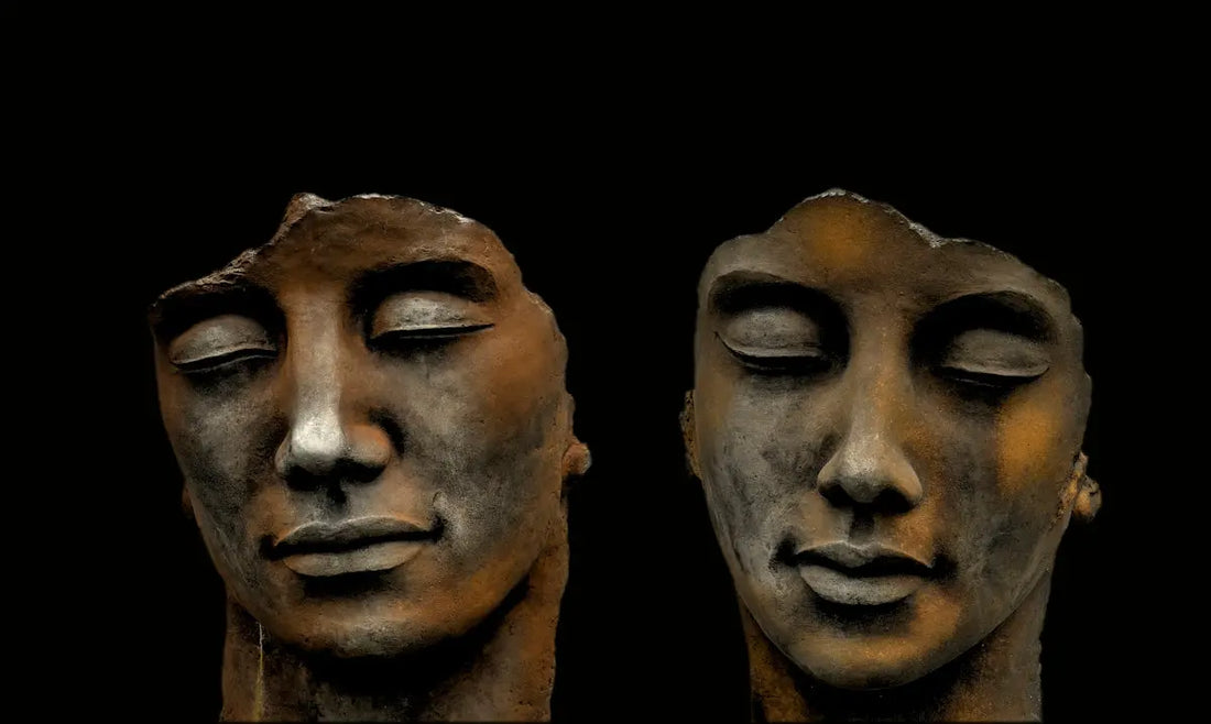 mans face carved on black surface