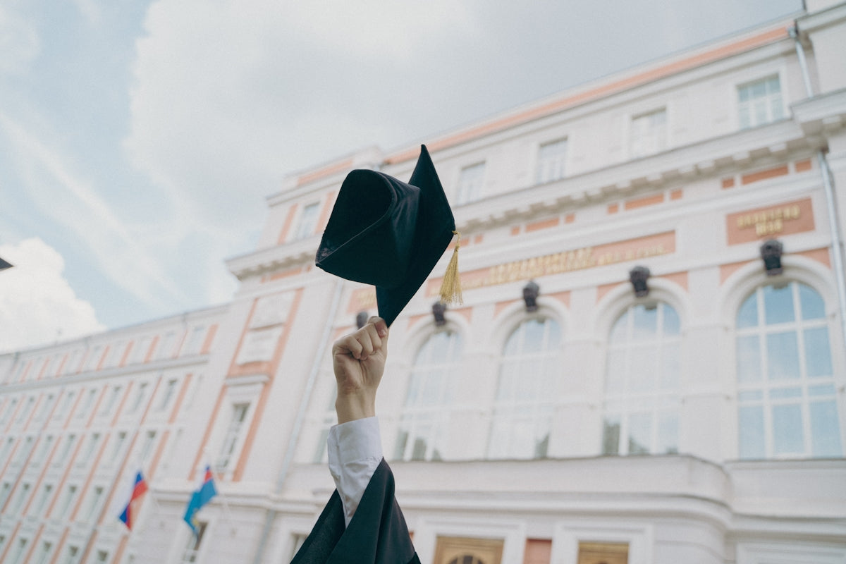 a person holding a black umbrella Image
